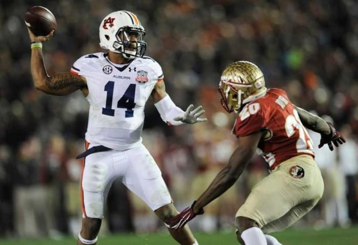 Auburn quarterback Nick Marshall (14) gets a pass away while defended by Florida State defensive back Lamarcus Joyner (20) in second half action of the BCS National Championship Game on Monday January 6, 2014 in Pasadena, Ca.